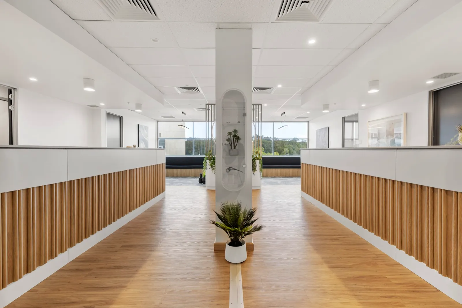 A light corridor with timber floors leading to the consulting rooms