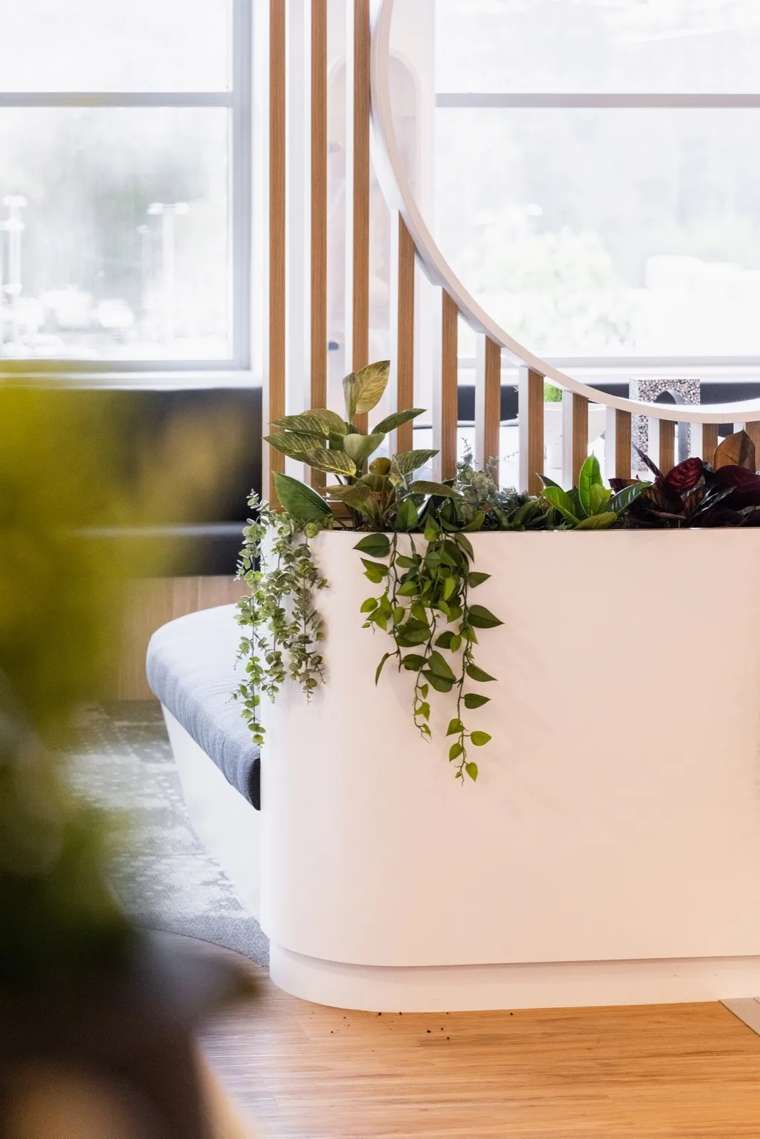 A waiting area with soft seating by a window
